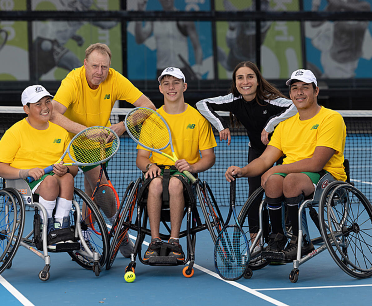 male and female coach and 3 male teenage tennis players in wheelchairs
