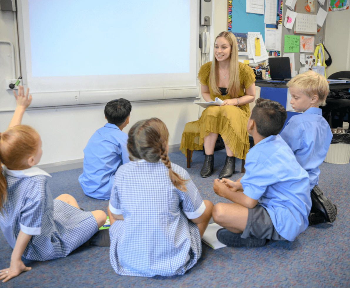 an image of a woman talking to a group of children
