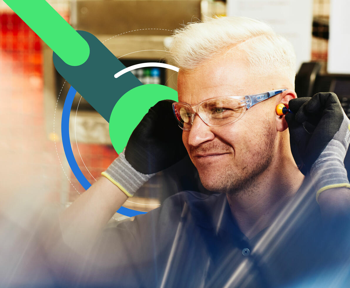 an image of a man wearing earplugs and protective glasses in the workshop