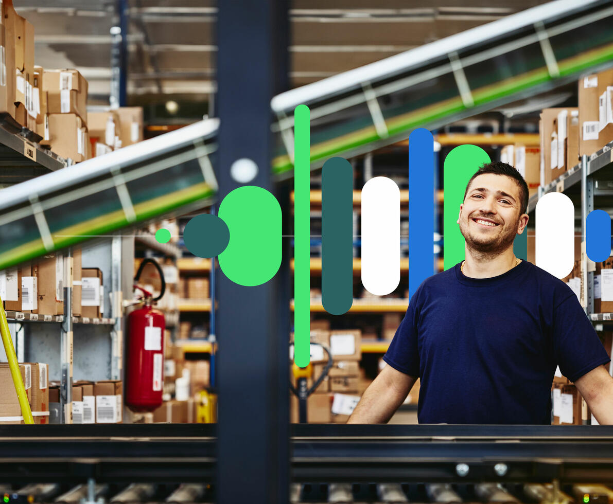 an image of a smiling man standing behind a conveyor belt