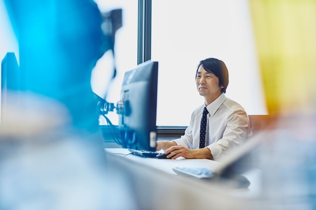 Man in his suit working on his desktop