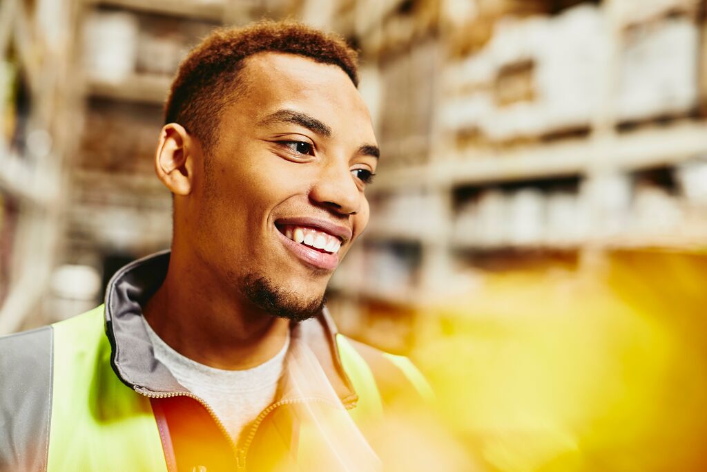 A photo of a man working as a forklift driver