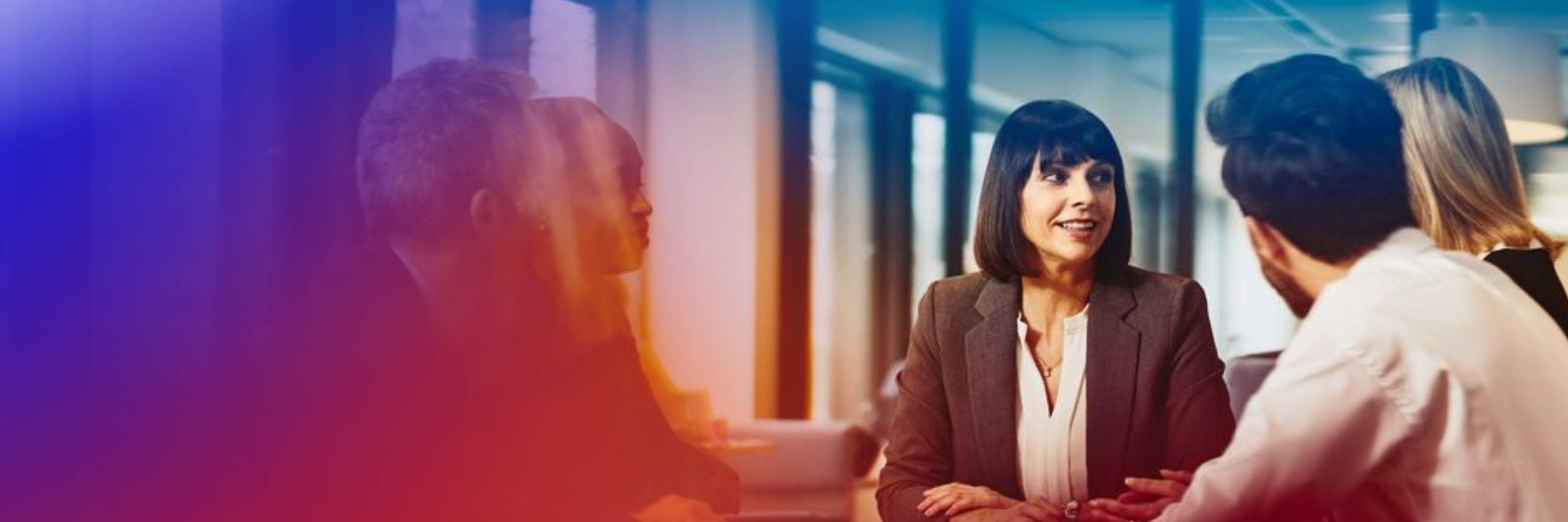 an image of people in a meeting discussing something while wearing business attires