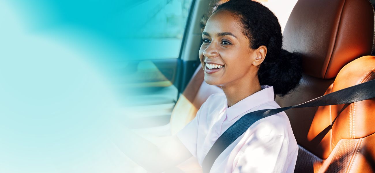 woman smiling driving a car