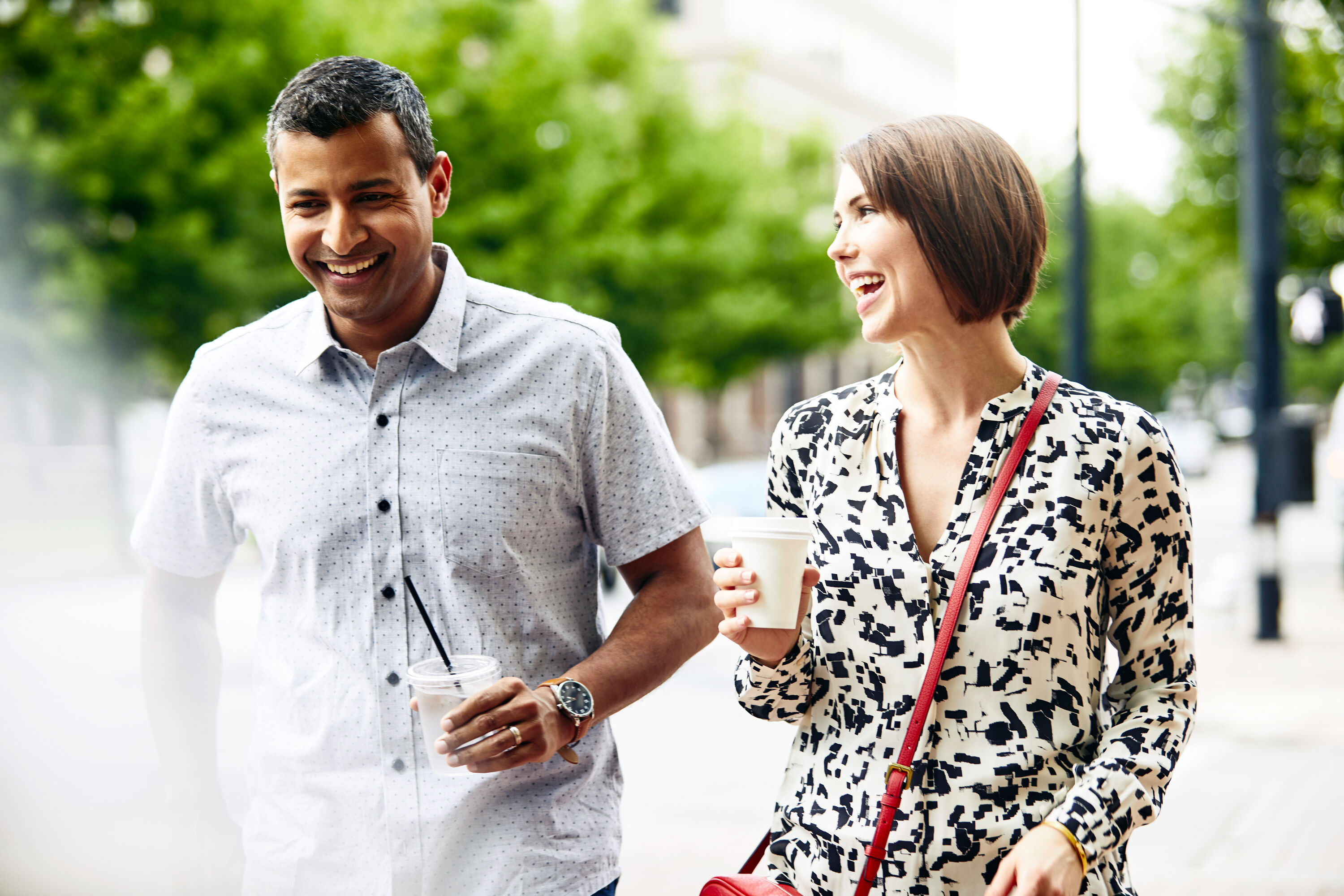 man and woman having a friendly chat drinking water and coffee