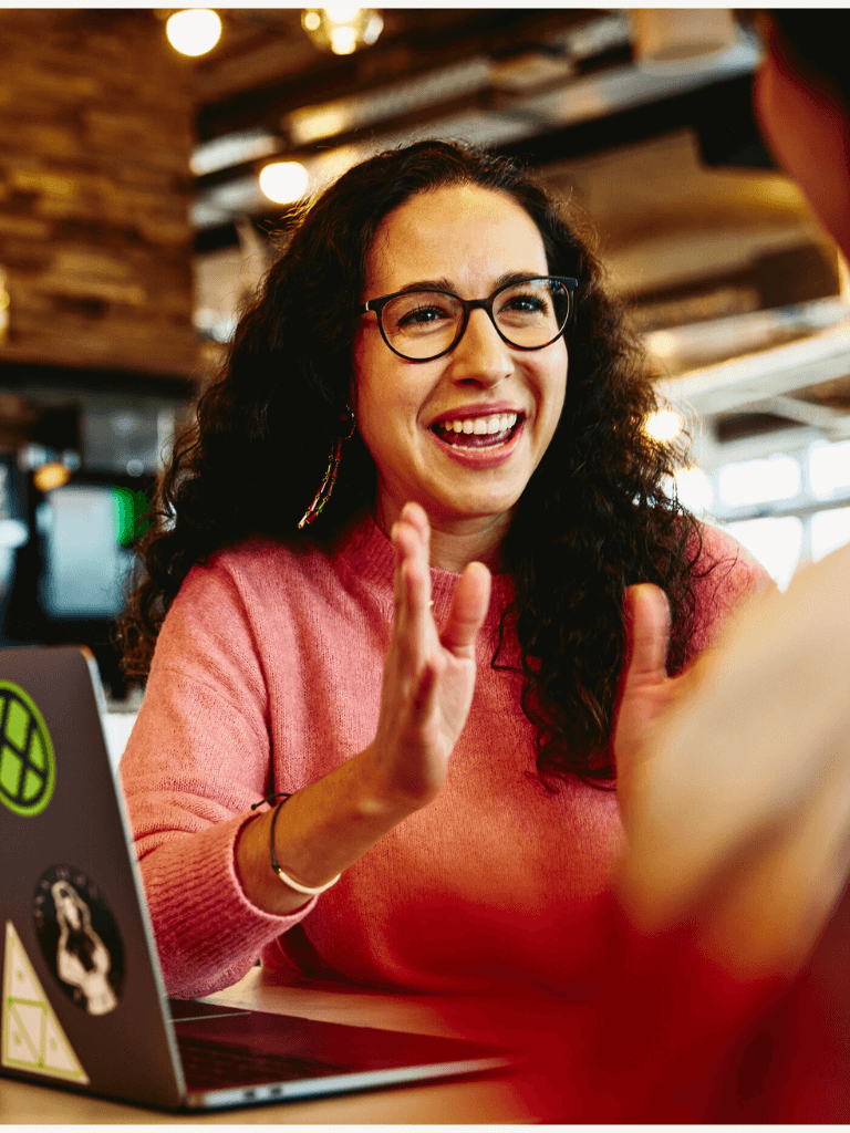 an illustration of a woman wearing glasses and a pink top talking with her coworker