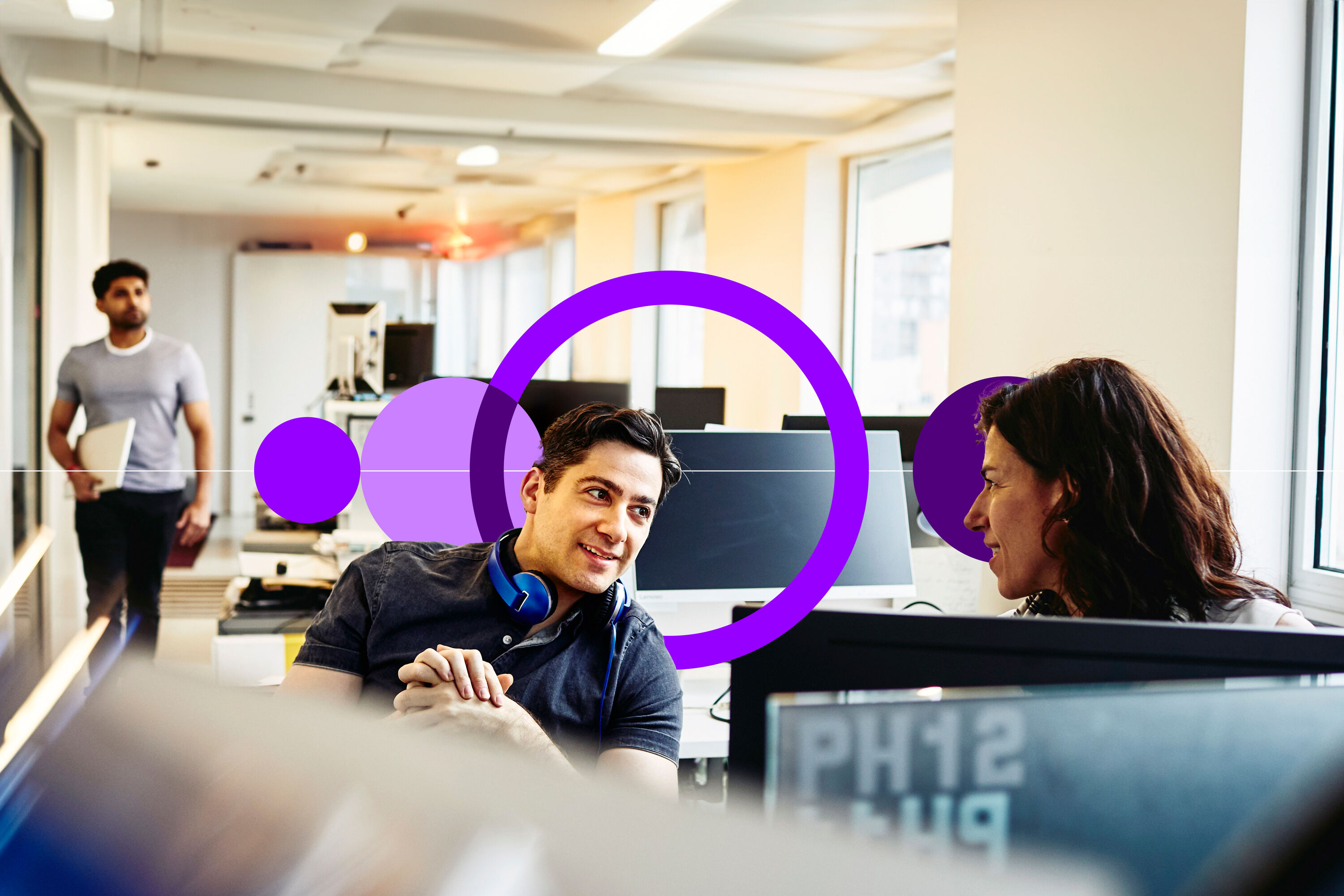 an image of a man and woman having a conversation in front of their desks