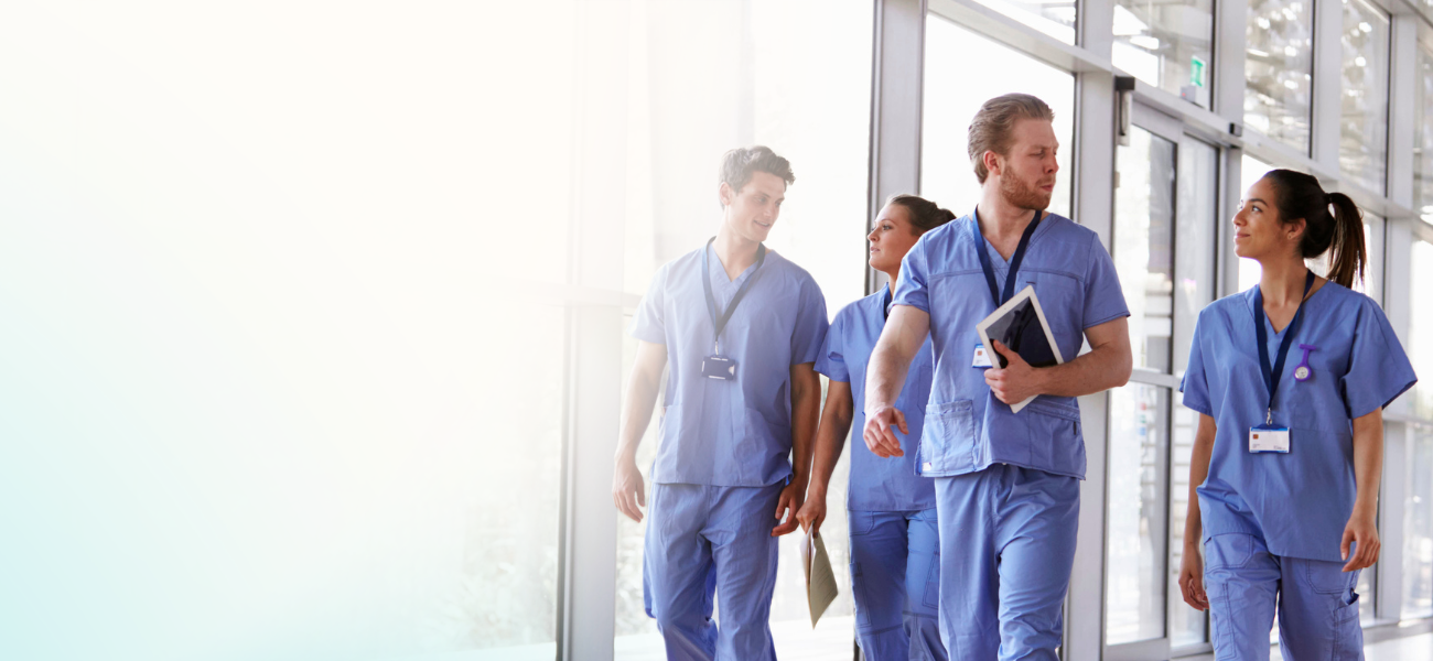 image of nurses walking through a healthcare facility having a conversation