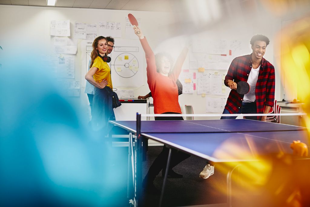 A group of people enjoying a game of table tennis