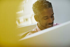 man smiling at computer in office