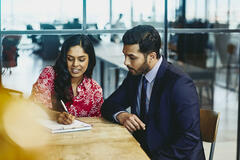 man and woman working together in office