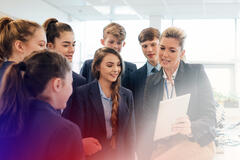 Woman explaining something to her students