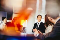 A group of people talking in a meeting room 