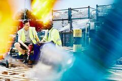 A photo of a man wearing a safety vest working in the construction sector