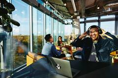 Man listening to music in a cafe with people talking in the back