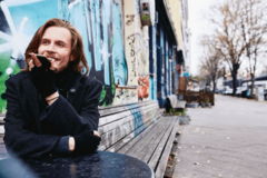Man sitting outside talking to his phone.