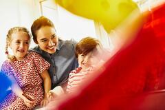 Smiling woman with three kids.