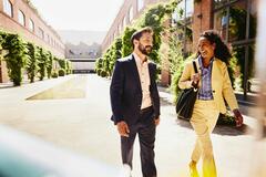 A man and woman walking in business attires