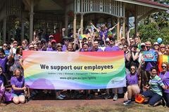 an image of an employee outing with the people holding a flag saying we support our employees
