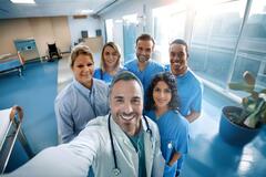 an image of doctors and nurses smiling at the camera