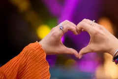 Close up of person making heart shaped hand gesture 