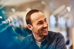 Male smiling and looking to the side
