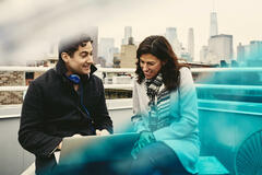 Man and woman on a rooftop talking