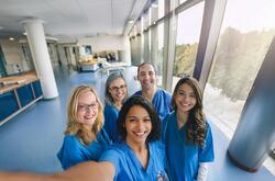 an image of nurses and doctors in scrubs smiling
