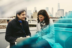 Man and woman on a rooftop talking