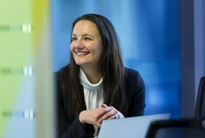 Ange Annasis smiling in a business suit