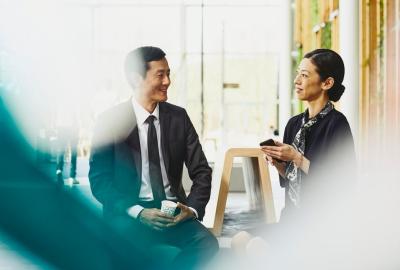 A photo of a woman working as an executive assistant with her immediate male supervisor