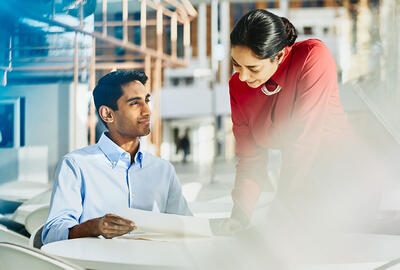 Man showing a paper to a woman