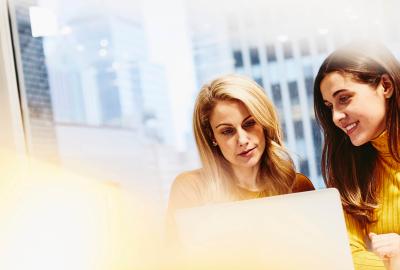 A photo of two women working together 