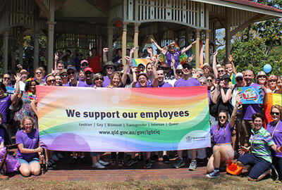 an image of an employee outing with the people holding a flag saying we support our employees