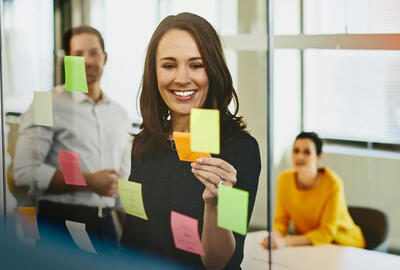 an image of placing sticky notes on the glass walls of the meeting room