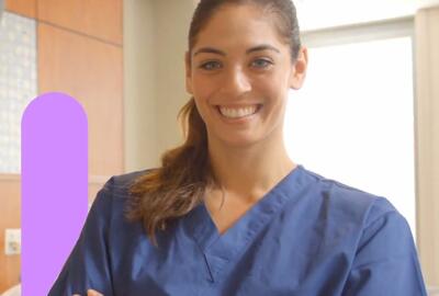 an image of a woman wearing scrubs smiling brightly