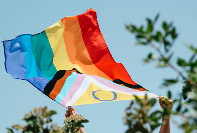 image of an intersex-inclusive progress pride flag being waved in the air