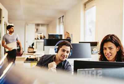 people working in an office boardroom