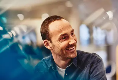 Male smiling and looking to the side
