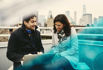 Man and woman on a rooftop talking