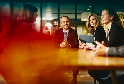 Group of people in a meeting smiling