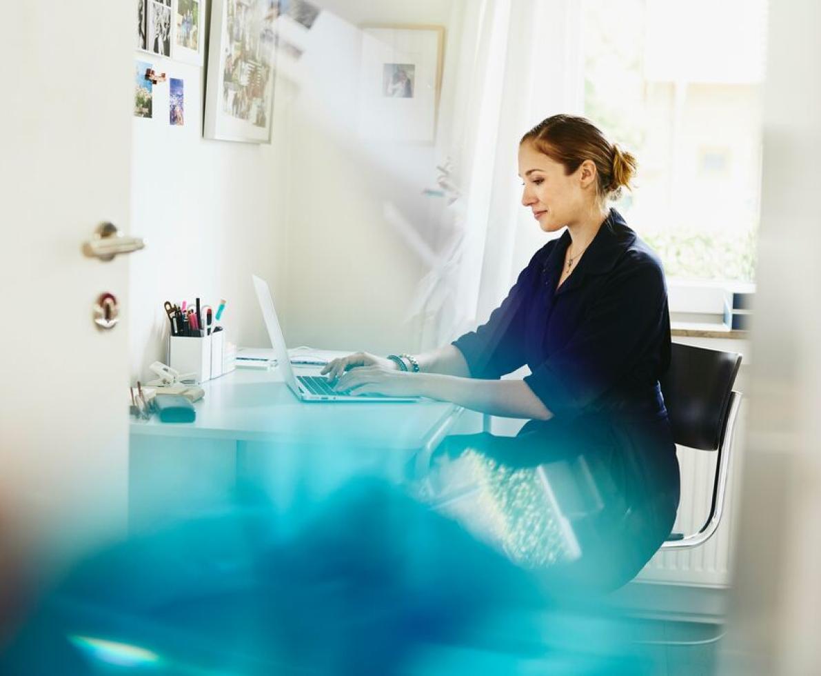 A woman typing on her laptop