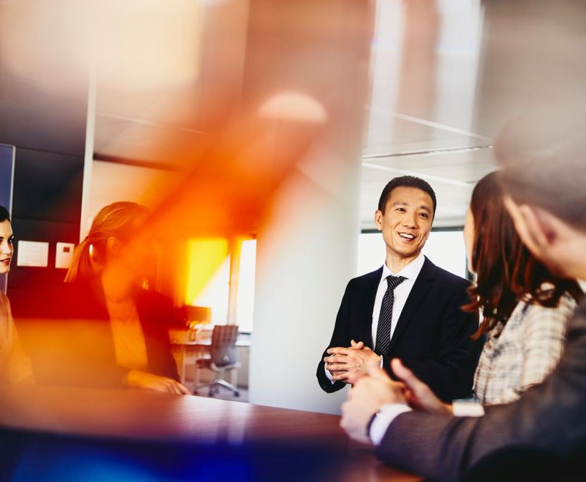 A group of people talking in a meeting room 