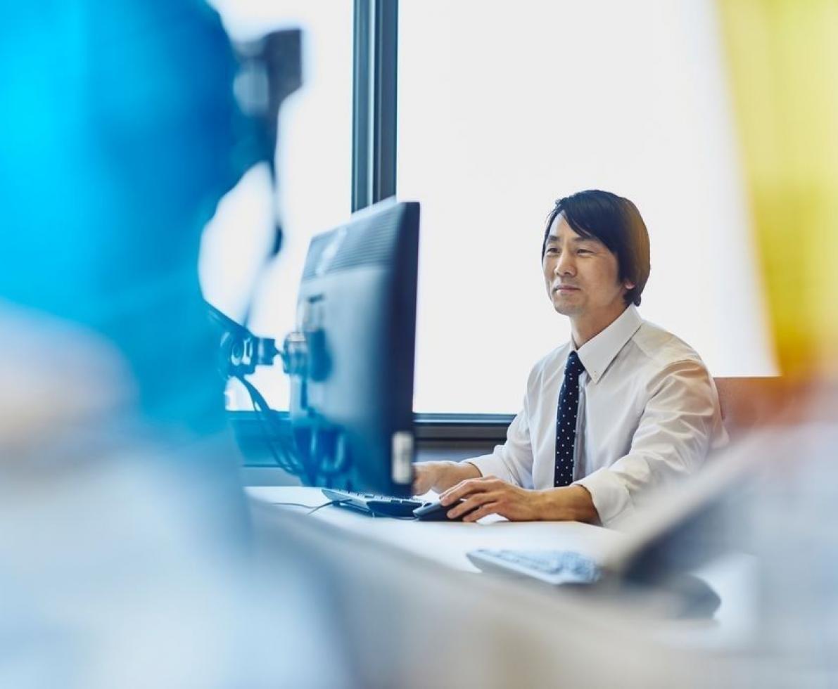 Man in his suit working on his desktop