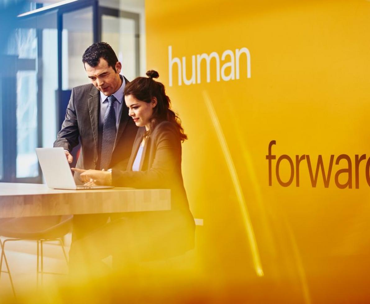 Man and woman looking at a laptop 