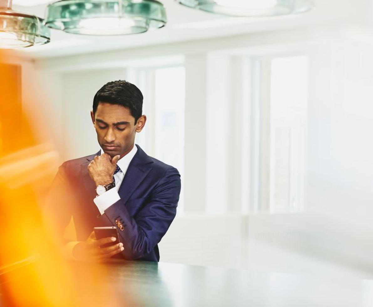 Man in suit looking at his phone