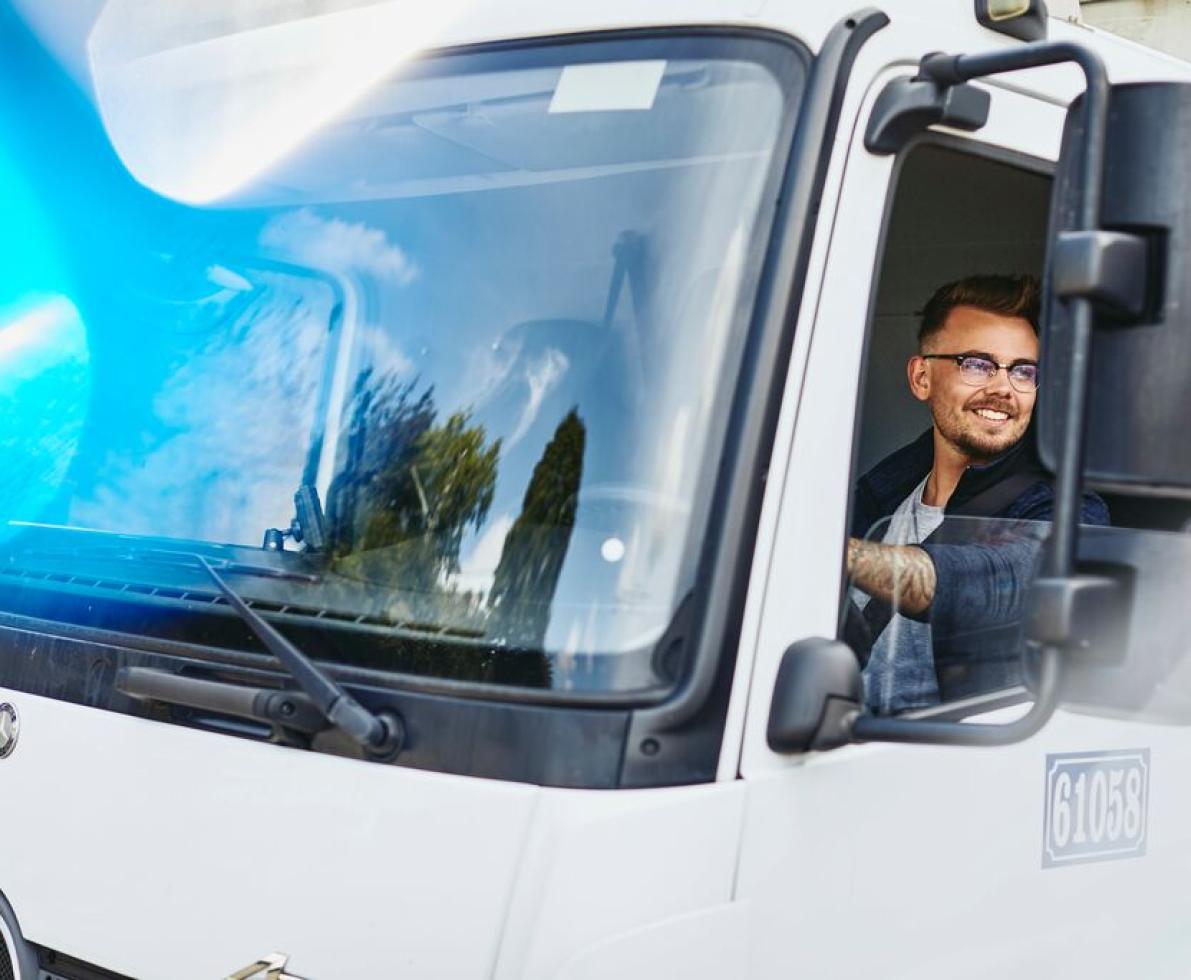 a man driving a truck to deliver goods