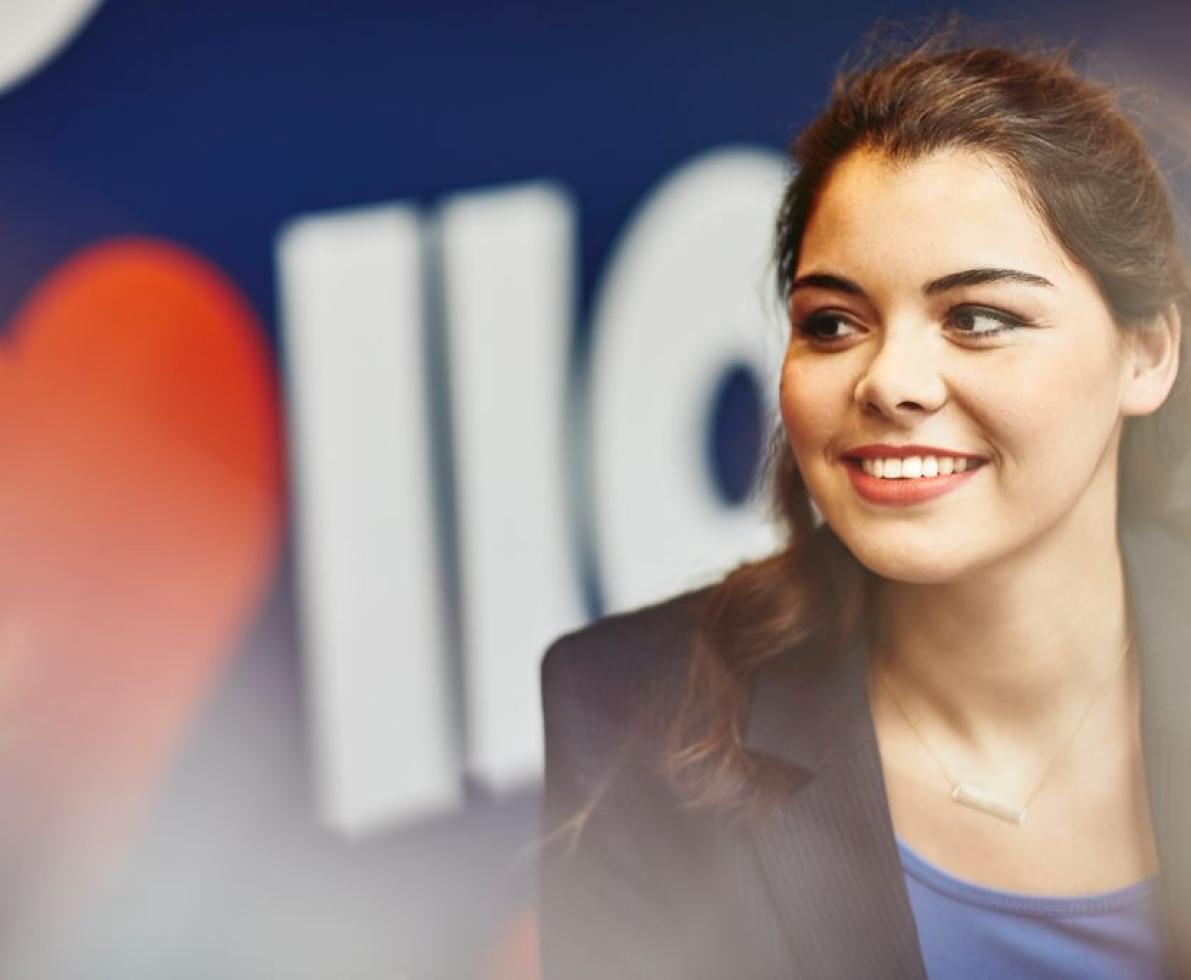 A woman smiling in a business attire