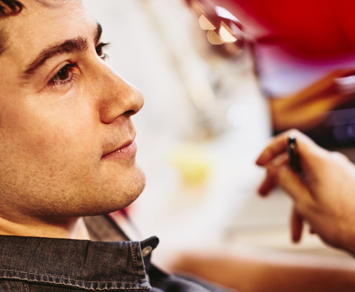 A man wearing a headset working in the customer service and business support sector