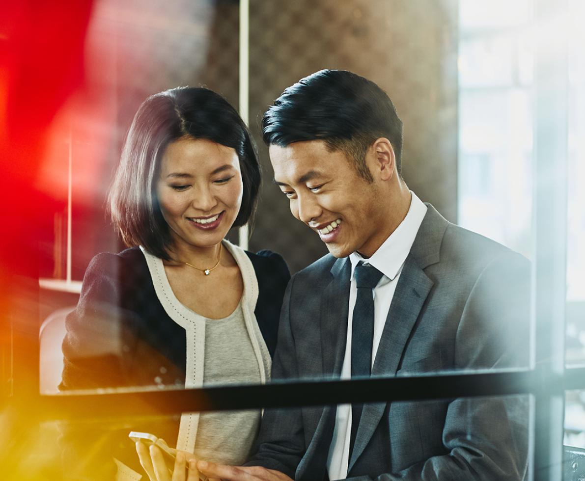 A photo of a man and a woman working in the banking and accounting sector